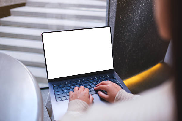 istock Mockup image of a woman working on laptop computer with blank white desktop screen in cafe 2246447441