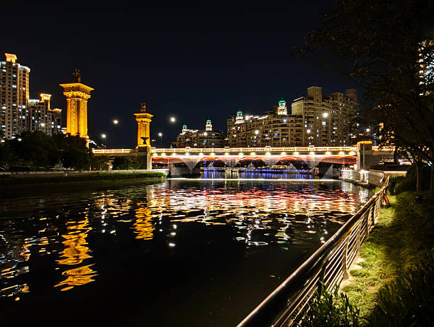 The Wuning Bridge, beautifully lighten at night, Putuo District, Shanghai. It was built in 1956 and is spanning Suzhou Creek for a length of 103 meters. Shanghai, China