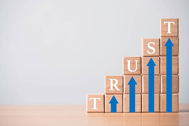 istock Wooden blocks stacked as steps spelling TRUST with blue arrows pointing upward symbolizing growth reliability and confidence in business teamwork success and corporate development 2246453061