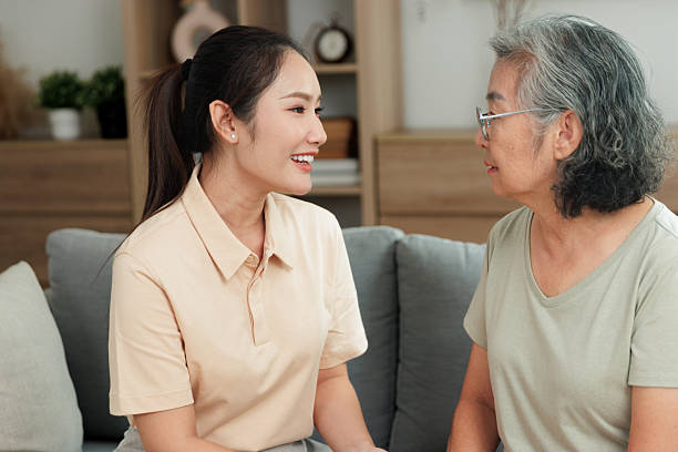 istock Caregiver talking with elderly woman during supportive home care visit 2246453133