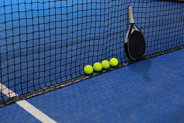 istock Net, balls and paddle racket on the blue court 2246456730