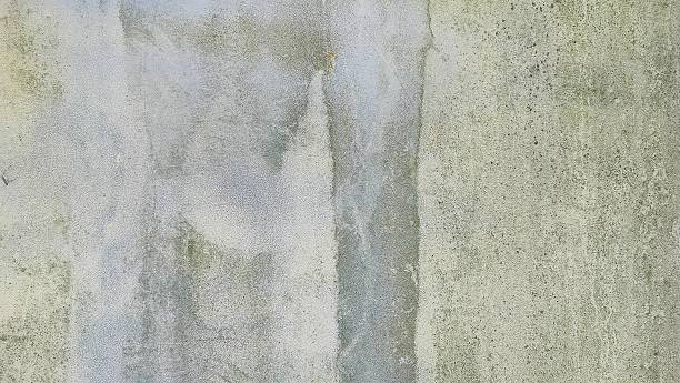 Iron wall background with faded blue paint because old and rusty. Blurred gray rusty grunge metal texture with Instagram style filter. vintage and mossy
