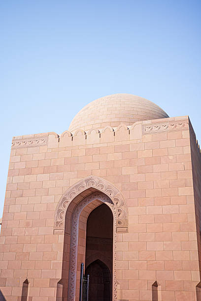 istock Sandstone Mosque Dome and Carved Archway Under Clear Sky in Oman 2246457966