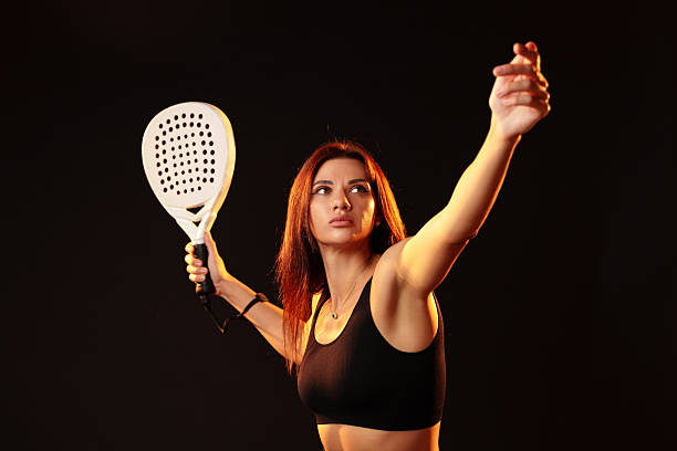 istock Female athlete prepares to serve in a studio with dramatic lighting 2246459655