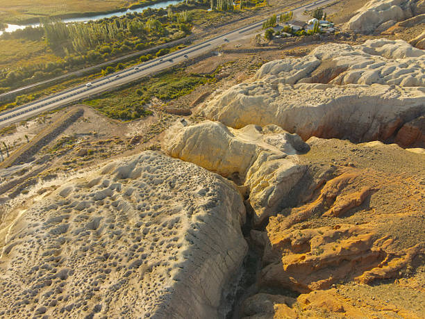 istock Highway runs past dramatic yellow and red eroded rock gorge 2246459886