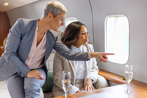 istock Two diverse businesswomen flying on a private jet 2246462643