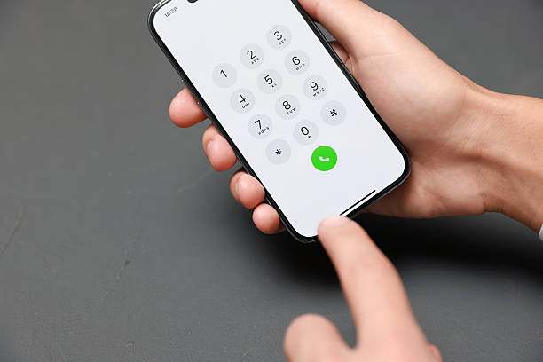 istock Man dialing number on smartphone at grey table, closeup. Space for text 2246462895