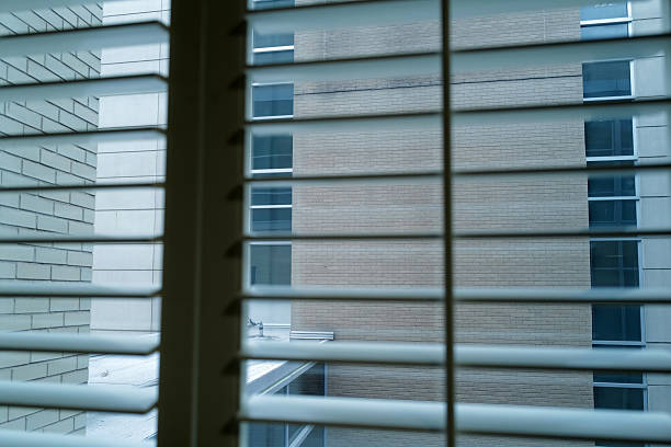 istock View of buildings from window shade frame 2246464409