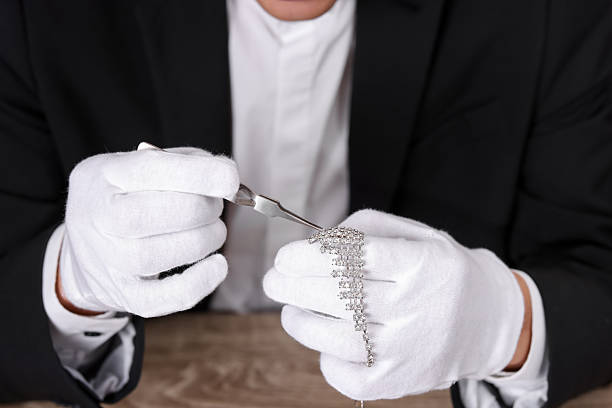 istock Appraiser with tweezers evaluating luxury necklace at table, closeup 2246464944