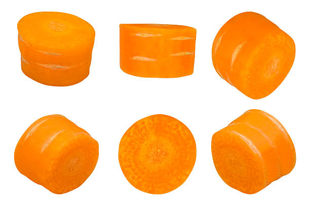 A tilted hat made from one whole carrot and a beard of green leaves. Isolated on a white background studio shot high quality image. Overhead view.