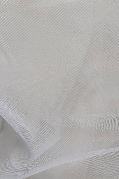 istock fabric for white tulle or curtains, finely woven synthetic threads for making tulle for windows in the home 2246465890