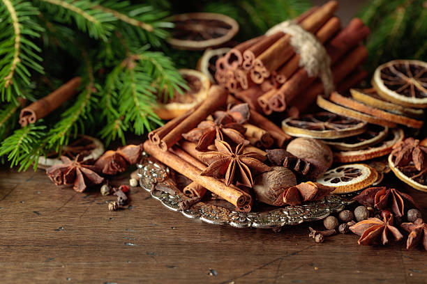 istock Various Christmas spices with dried citrus slices on silver tray. 2246466223
