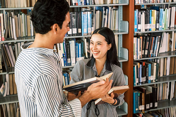 portrait of young concentrated female student read a book in the library