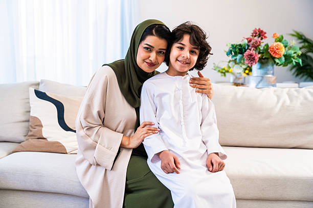 istock Emirati mother and son sitting on sofa at home 2246468156
