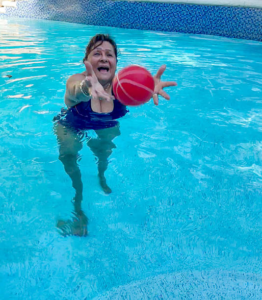 istock Attractive Hispanic senior woman in pool 2246470345