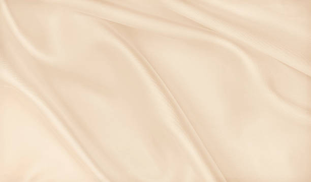 istock Smooth elegant golden silk or satin luxury cloth texture as wedding background. Luxurious Christmas background or New Year background design. In Sepia toned. Retro style 2246471200
