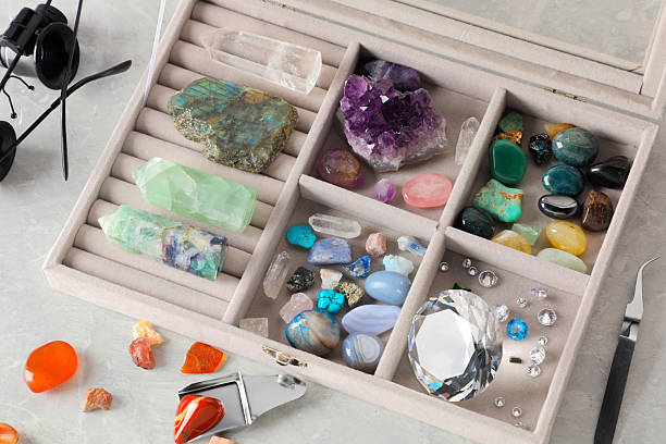 istock Box with beautiful gemstones and jeweler's tools on light table, closeup 2246471257