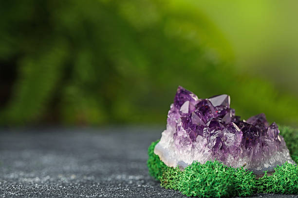 istock Beautiful amethyst gemstone and moss on grey textured table. Space for text 2246471279