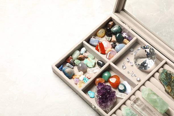 istock Box with beautiful gemstones on light table, closeup. Space for text 2246471307