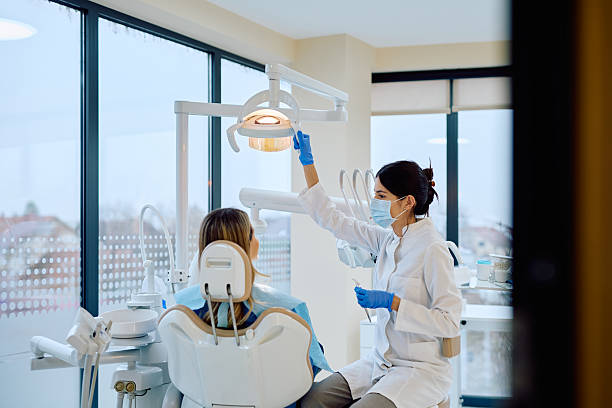 istock Dentist adjusting lamp before patient's dental checkup 2246474070