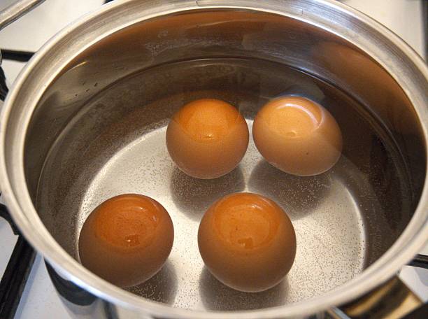 istock Four brown chicken eggs boiling in a cooking pan 2246474278
