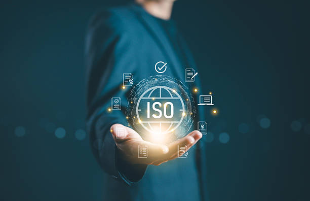 istock Businessman holding digital ISO icon with certification documents, symbolizing international standards, quality control assurance, compliance, regulation, auditing, and global business certification. 2246474541