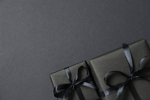 istock Top view of gift boxes tied with bows on black background 2246475047