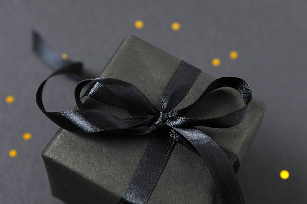 istock Festive black gift on a dark background 2246475052