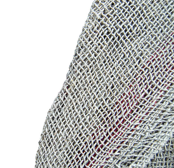 Cutout of woven old burlap sack mop cloth making a rustic uneven  grid pattern cloth fibre textured gray brown buff  colored cloth for wiping floor called pocha in hindi isolated over white background leaving copy space.