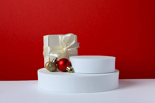 istock White podiums and Christmas decor on two-tone background 2246475178