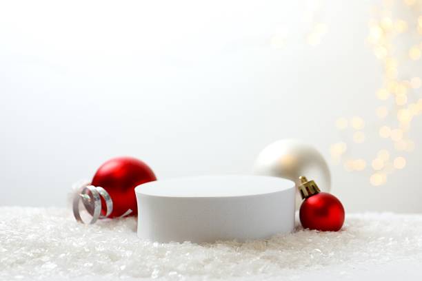 istock White podium, Christmas decor, white snow and bokeh lights 2246475244