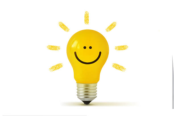 Yellow light bulb with smile on white background - Concept of ideas and creativity