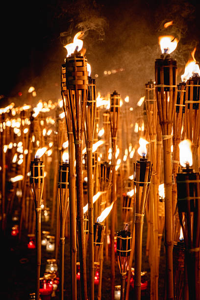istock Vertical Composition of Burning Torches at Night  Memorial Firelight Ceremony 2246475730