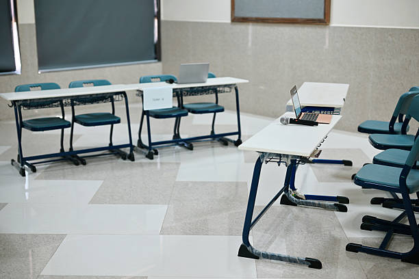 Empty classroom with desks and chairs for music lessons .