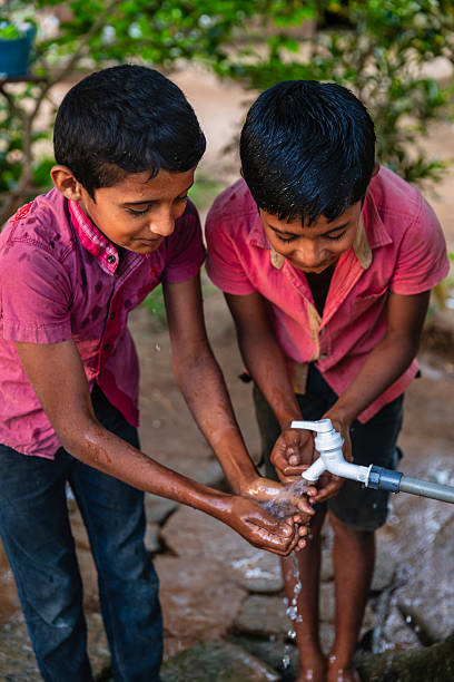 istock Sri Lankan young boys drinking a water, Ceylon 2246476819