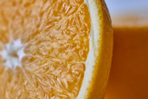 istock Close up of a juicy orange slice texture 2246477495