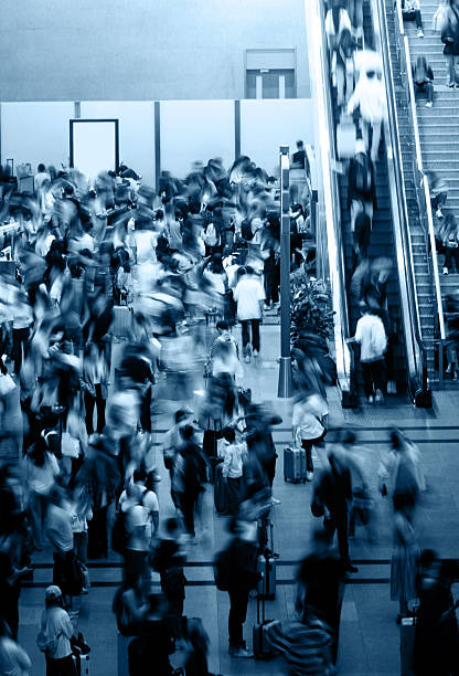 istock Crowd of passengers walking through escalator and staircase at a railroad station 2246478556