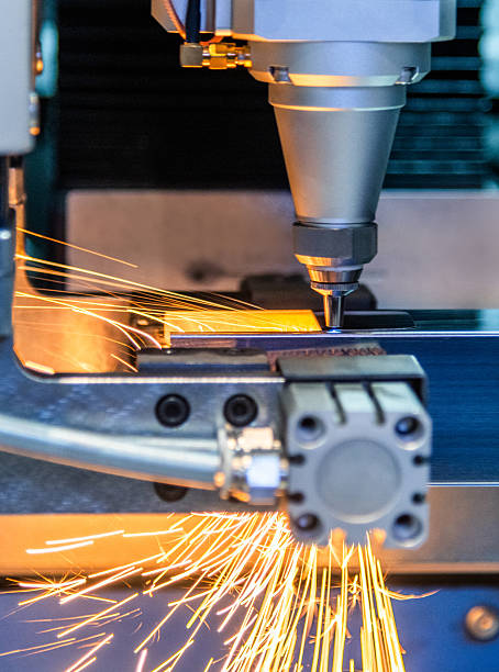 istock CNC laser cutting metal sheet with sparks flying 2246478663