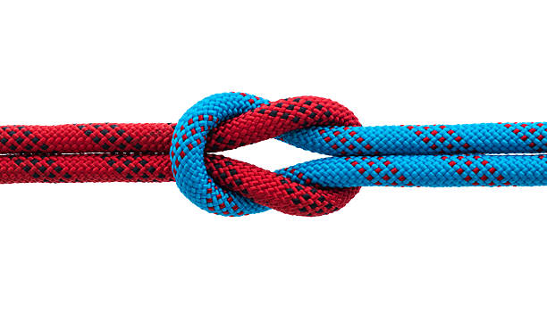 istock Red and blue ropes with reef knot isolated on white background 2246478764