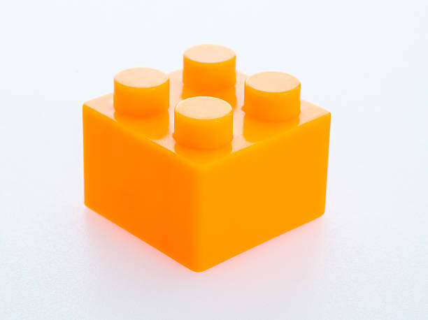 Orange plastic toy block on white background