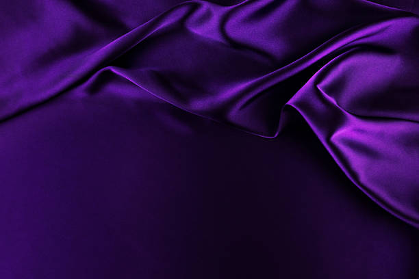 istock Purple satin background. Soft folds on shiny fabric. Luxurious backdrop with space for design. Flat lay, top view. Template. 2246479615