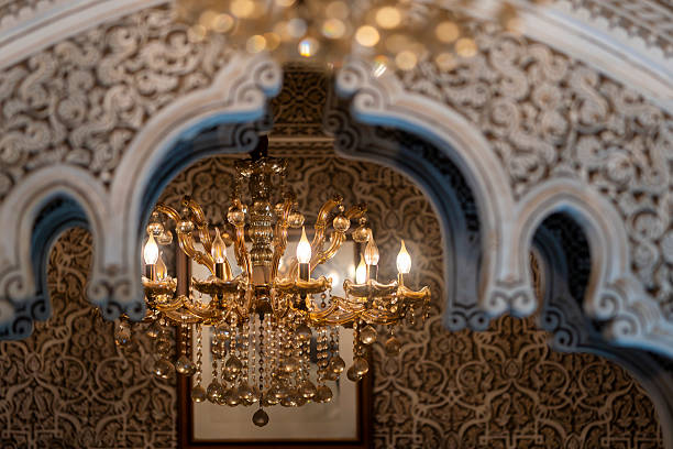 istock Golden chandelier glowing beneath ornate Moroccan arches with  stucco patterns. 2246479647