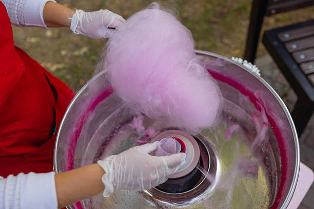 istock People make cotton candy for children close-up. 2246480559