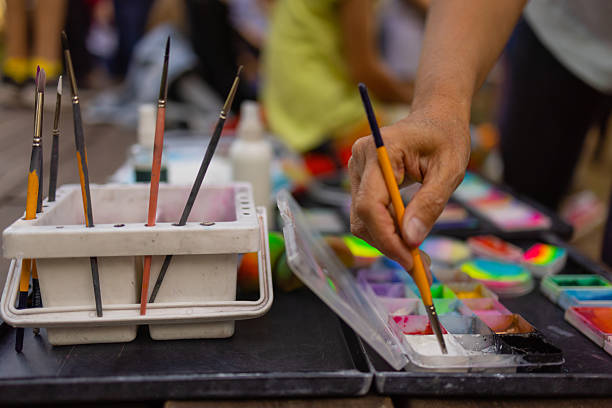 Colorful paint tubes on a table with paints used for face art