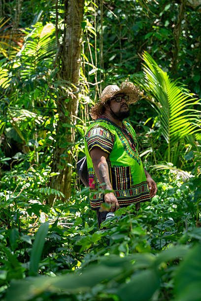istock Costa Rican guide exploring jungle holding camera, surrounded by lush tropical foliage 2246483408