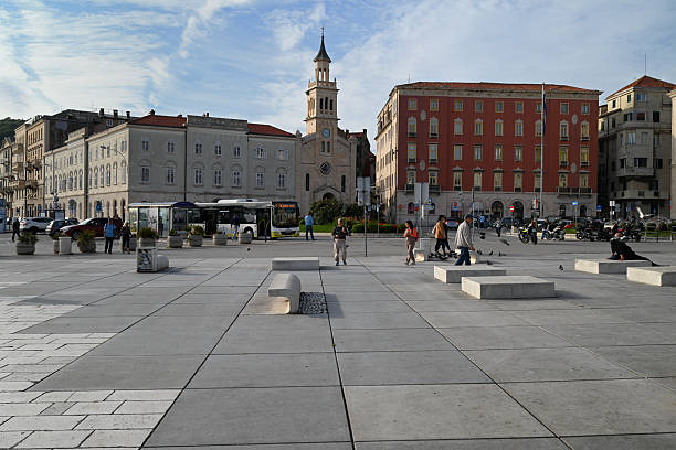 Split, Croatia, october 20, 2025 : Tourists in Franje Tudmana Square in Split with the Church and Convent of St. Francis in Split in the background