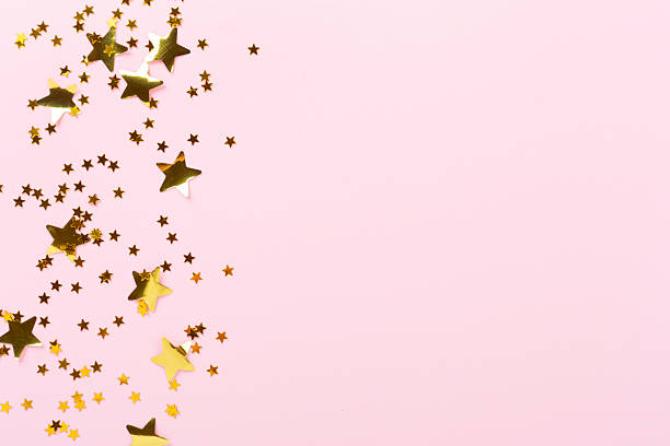 istock Golden star shape confetti on color background, top view 2246483732