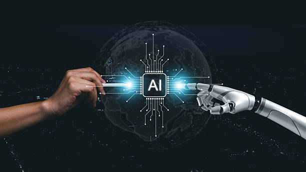 istock Human hand holding a digital pen reaching toward a robotic hand beside a glowing AI chip, representing advanced technology, human-machine interaction, innovation, the future of intelligent systems. 2246484265