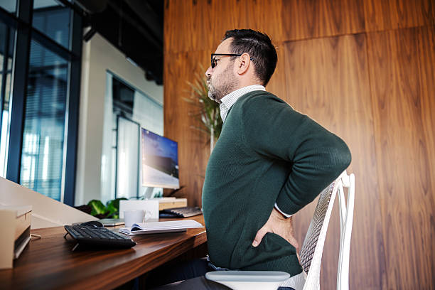 istock Businessman having lower back pain at office desk 2246485591