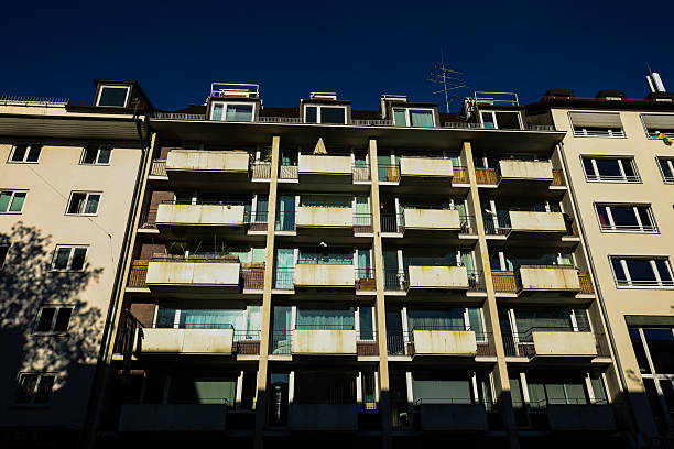 istock Urban Apartment Building with Balconies Under Deep Blue Sky 2246485948